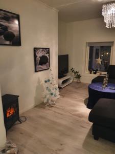 a living room with a christmas tree in the corner at Modern villa for rent in Lavangen