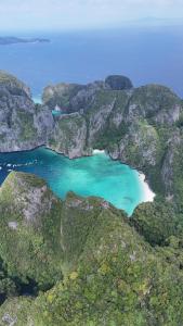 an aerial view of a beach surrounded by mountains at Hangover Chill & Hill Hostel in Phi Phi Islands