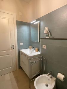 a bathroom with a sink and a toilet at Castello D'Alcontres Guest House 3 stelle in Nizza di Sicilia