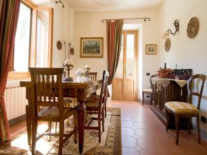 a dining room with a wooden table and chairs at Villa La Fonte 13 in San Godenzo