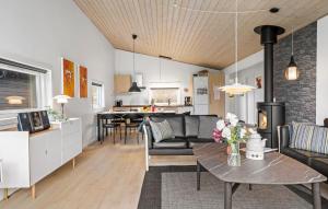 a living room with a couch and a table at Holiday Home Vestervig 44 in Vestervig