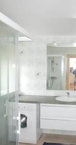 a white bathroom with a sink and a mirror at Maison charmante à Botsorhel avec jardin clos in Botsorhel
