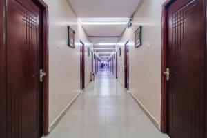a long corridor with doors and a long hallway at Super Townhouse Gajuwaka Near CMR Mall in Visakhapatnam