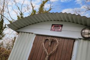 a sign on top of a door with a heart at Foxes Walk - Rural Views Rustic Charm in Templeton