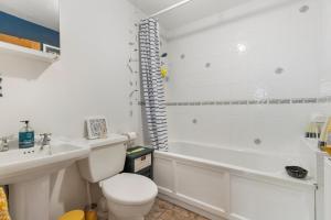 a white bathroom with a toilet and a sink at Foxes Walk - Rural Views Rustic Charm in Templeton