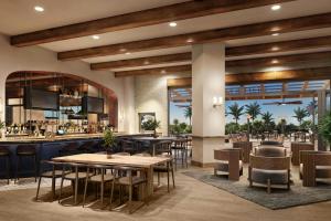 a restaurant with tables and chairs and a bar at Gaylord Pacific Resort & Convention Center in Chula Vista