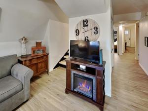 a living room with a fireplace and a tv at Docs Den in Ruidoso +30 photos