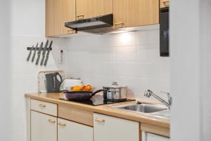 a kitchen with a sink and a counter top at Großer Garten mit Grill,-Spiel und Sitzmöglichkeiten-umgeben von schöner Natur-Ferienhaus Albmatte in St. Blasien