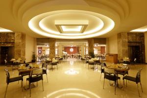 a restaurant with tables and chairs and a large ceiling at Pickalbatros White Beach Resort - Hurghada in Hurghada