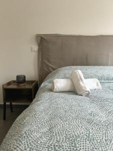 a bed with two towels on top of it at Sant Agata House in Ravenna