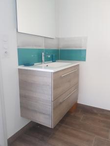 a kitchen with a sink and a mirror at VIlla Elise, lumineuse et proche plage in LʼÉpine +13 photos