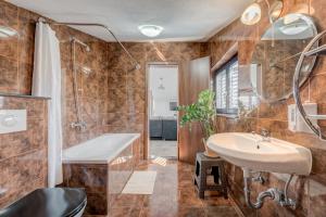a bathroom with a sink and a tub and a shower at Apartments Deepwater in Slatine +42 photos