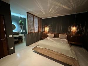 a bedroom with a large bed with a wooden headboard at Bahari View, Stylish Penthouse with breathtaking oceanviews and private rooftop pool in Kiwengwa +39 photos