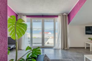 a living room with a large sliding glass door at Apartments Deepwater in Slatine