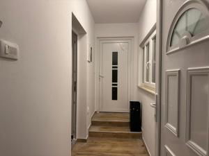 a hallway with white walls and wooden floors at Apartment Marta - free parking! in Split