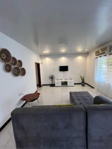 a living room with a couch and a tv at Kasuba Apartments in Livingstone