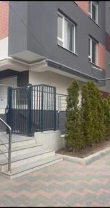 a building with stairs and bushes in front of it at Glamour Apartment in Chişinău