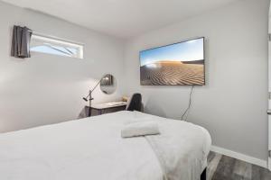a bedroom with a bed and a desk and a window at Entire Private 2-Bedroom Home w Gated Yard, Driveway Parking, Available Now in Spring Valley