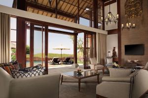 a living room filled with furniture and a large window at Hilton Bali Resort in Nusa Dua