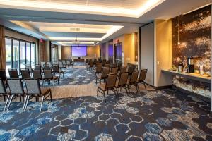a conference room with chairs and a projection screen at Hilton Garden Inn Redmond WA in Redmond