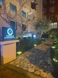 a walkway in front of a building at night at Nebula Apartments in Tirana