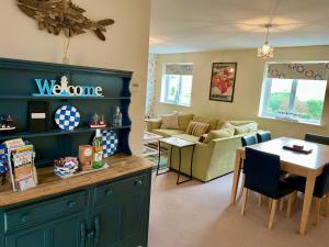 a kitchen and living room with a couch and a table at The Coach House in Par +27 photos