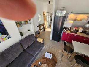a living room with a couch and a refrigerator at Hayarkon Superior TLV Beach 7B in Tel Aviv +18 photos