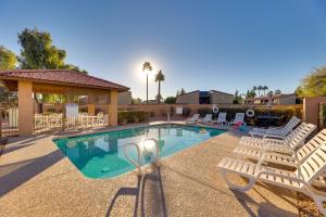 a swimming pool with white chairs and a swimming poolvisor at 3 Mi to Dtwn Mesa Townhome with Patio in Mesa