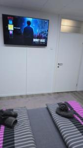 a room with two beds and a flat screen tv at Stan na dan Bosanska Krupa in Bosanska Krupa