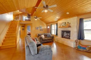 a living room with a couch and a fireplace at Private Hot Tub and Pickleball Court Baird Home! in Baird