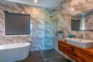 a bathroom with a tub and a sink and a shower at Scenic Lamai Getaway in Amphoe Koh Samui +13 photos