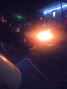 a group of people sitting down with a fire at night at Country living in Pine Mountain