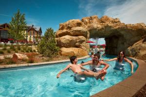 a group of people sitting in a swimming pool at Gaylord Rockies Resort & Convention Center in Aurora