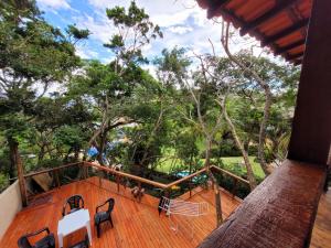 a balcony of a house with trees in the background at Nosso lar na Ferradurinha in Búzios
