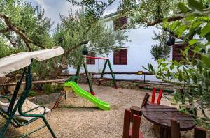 a playground with a slide and a swing set at Apartment Damir in Tučepi