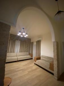 a large living room with white couches and a brick wall at The view stay in Baabda