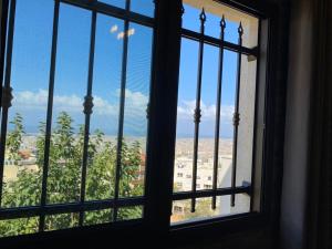 a window with a view of a city at The view stay in Baabda