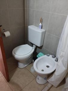 a bathroom with a toilet and a sink at CARRERO Departamentos Apart in Chepes +8 photos