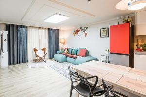 a living room with a blue couch and a table at Haeundae Beach Bexco in Busan +31 photos