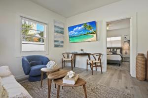 a living room with a couch and a table at Draper Bungalow By CoastVH - Charming 1940 in San Diego