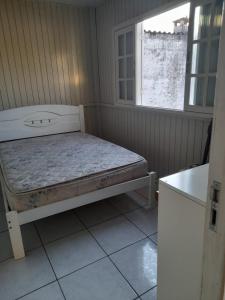 Ένα ή περισσότερα κρεβάτια σε δωμάτιο στο Casa temporada, balneario rincao