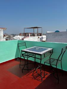 a table and chairs sitting on top of a roof at Entire Studio Steps From The Kasbah Museum In The Ancient City in Tangier