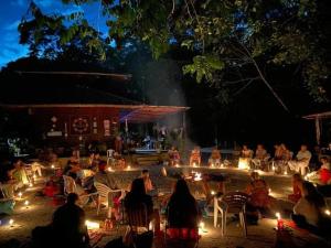 a group of people sitting in chairs at night at Floresta Zen - Pousada Xamanica in Manaus