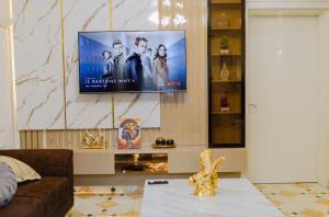 a living room with a flat screen tv on a wall at Apo Resettlement Retreat in Abuja in Abuja