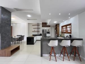 a kitchen with a counter and some stools at Casa para Veraneio in Capão da Canoa
