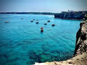 a group of boats in a large body of water at ONDA BLU-Appartamenti in Torre dell'Orso