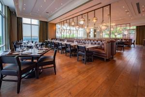 a dining room with tables and chairs and windows at Gaylord National Resort & Convention Center in National Harbor