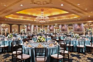 a ballroom with tables and chairs and a chandelier at Gaylord Opryland Resort & Convention Center in Nashville +71 photos