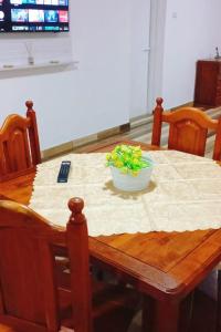a wooden table with a bowl of greens on it at Mabrouk in La Rioja