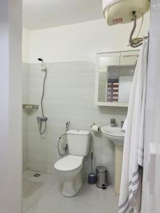 a bathroom with a toilet and a sink at Furnished studio in Mermoz in Dakar